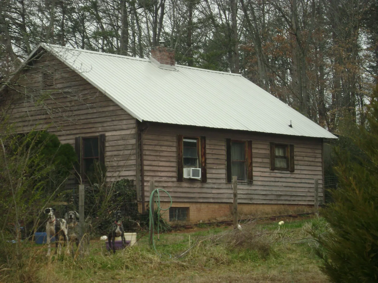 White metal roof on an old wood sided farmhouse, from a Metal Roof Installation job in Thiells